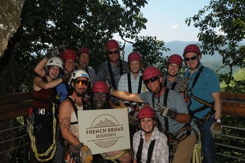 group of zipliners holding FBA sign