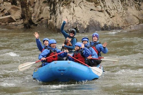 front view of rafting group waving