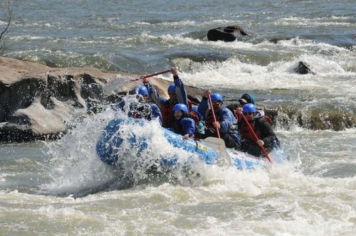 French Broad rafting trip hitting rapids on the river.
