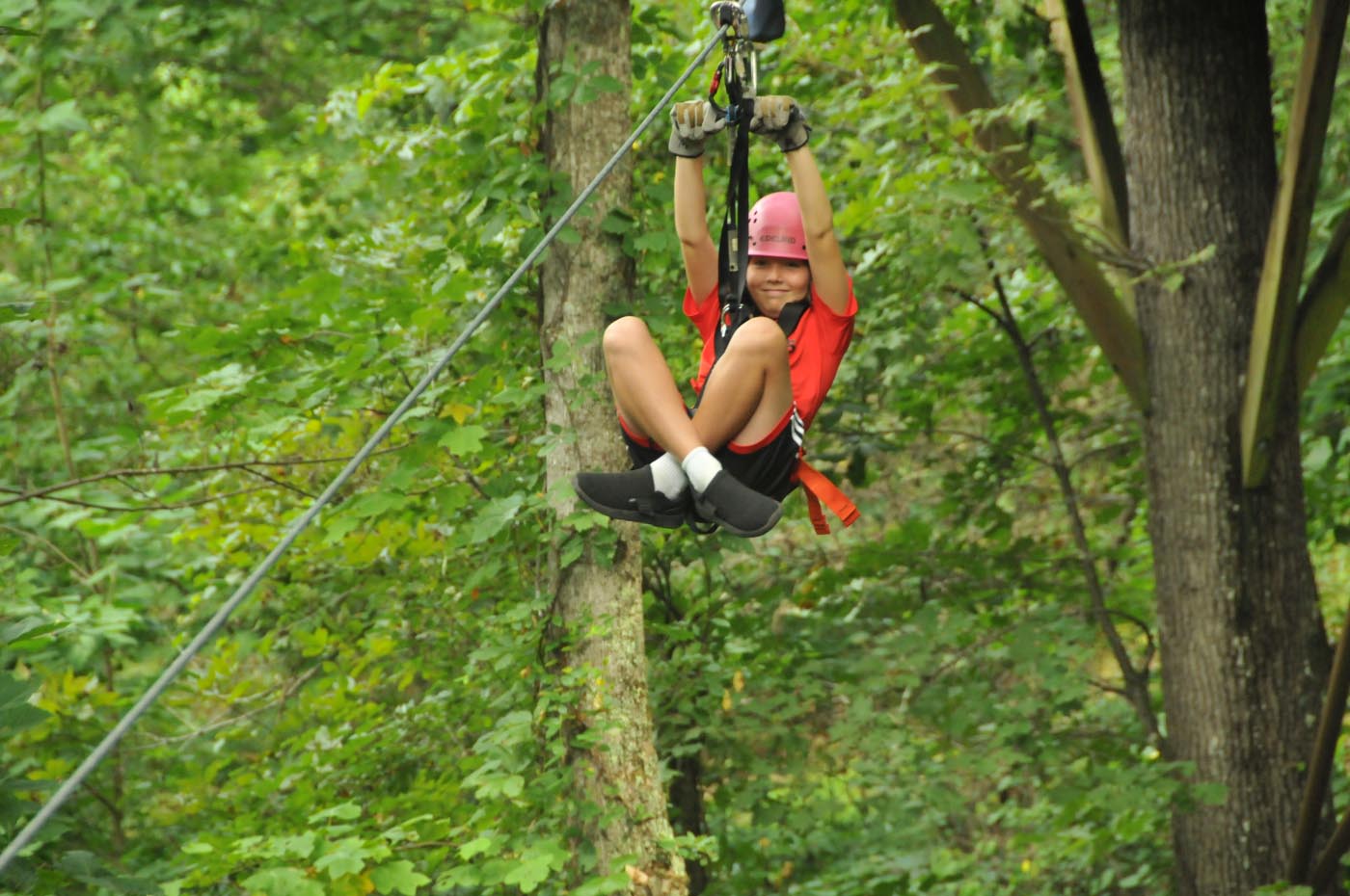 Young child zipping through the trees
