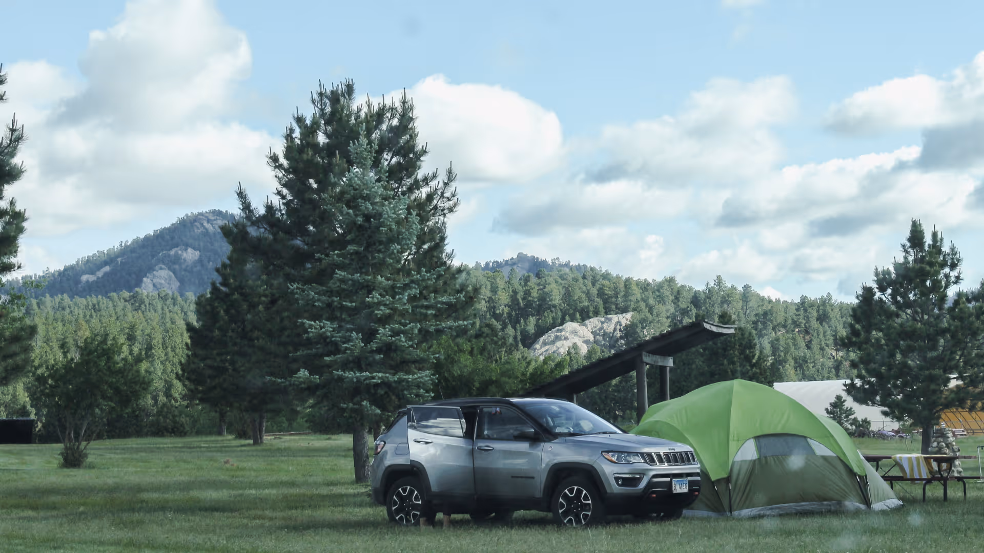 car and tent with pretty scenery