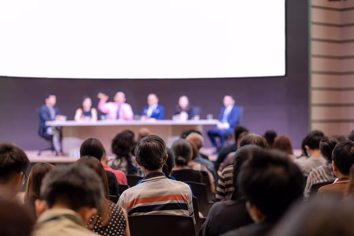 Conference attendees listen as speakers present valuable insights
