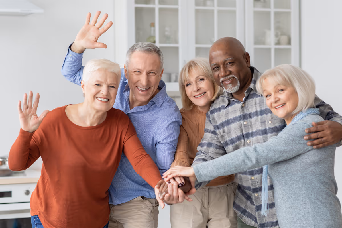 Multiracial group of senior adult friends holding hands