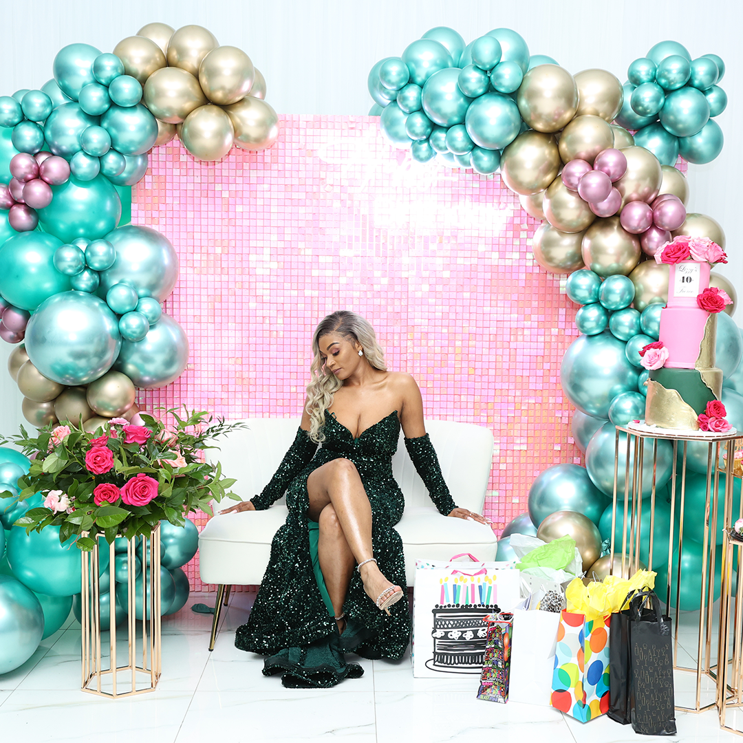 Still Blooming birthday event with large bouquets and balloon decorations.
