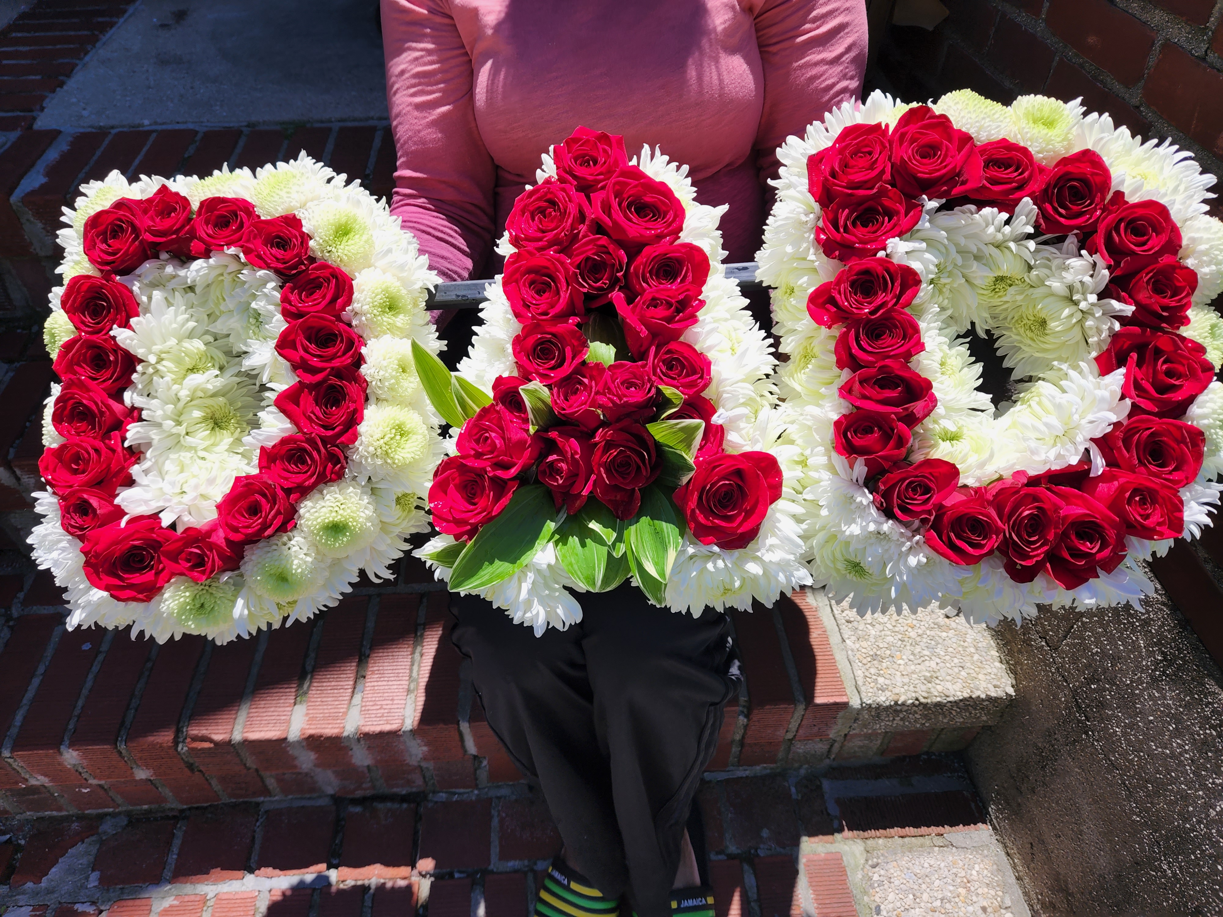 Customized floral design spelling "DAD" with red and white flowers.