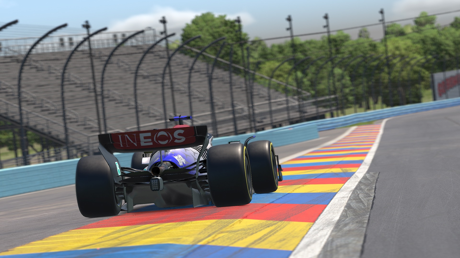 A race car driving at high speed on a racetrackA race car driving at high speed on a racetrack