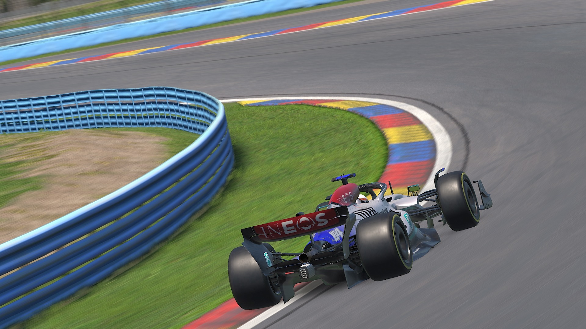 A race car driving at high speed on a racetrack