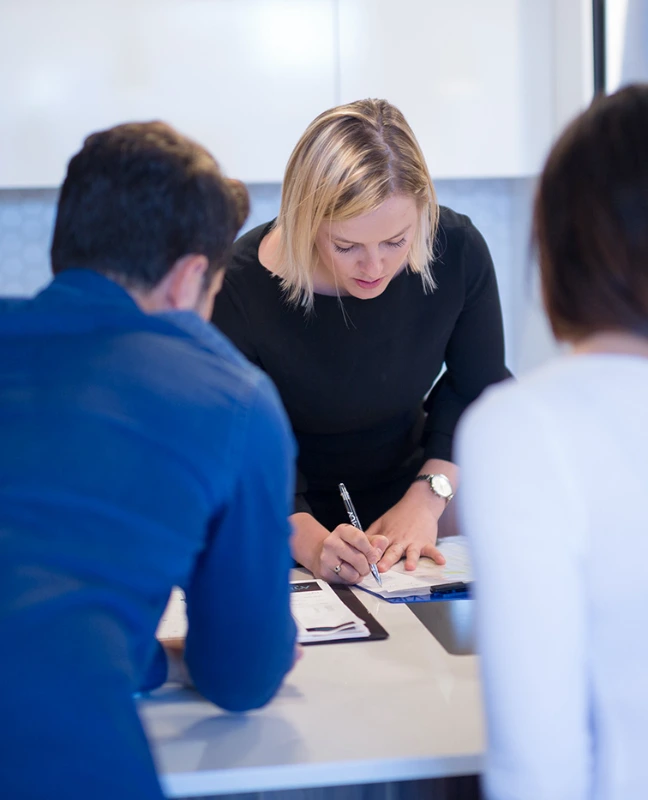 Sales person signing a lease with two clients