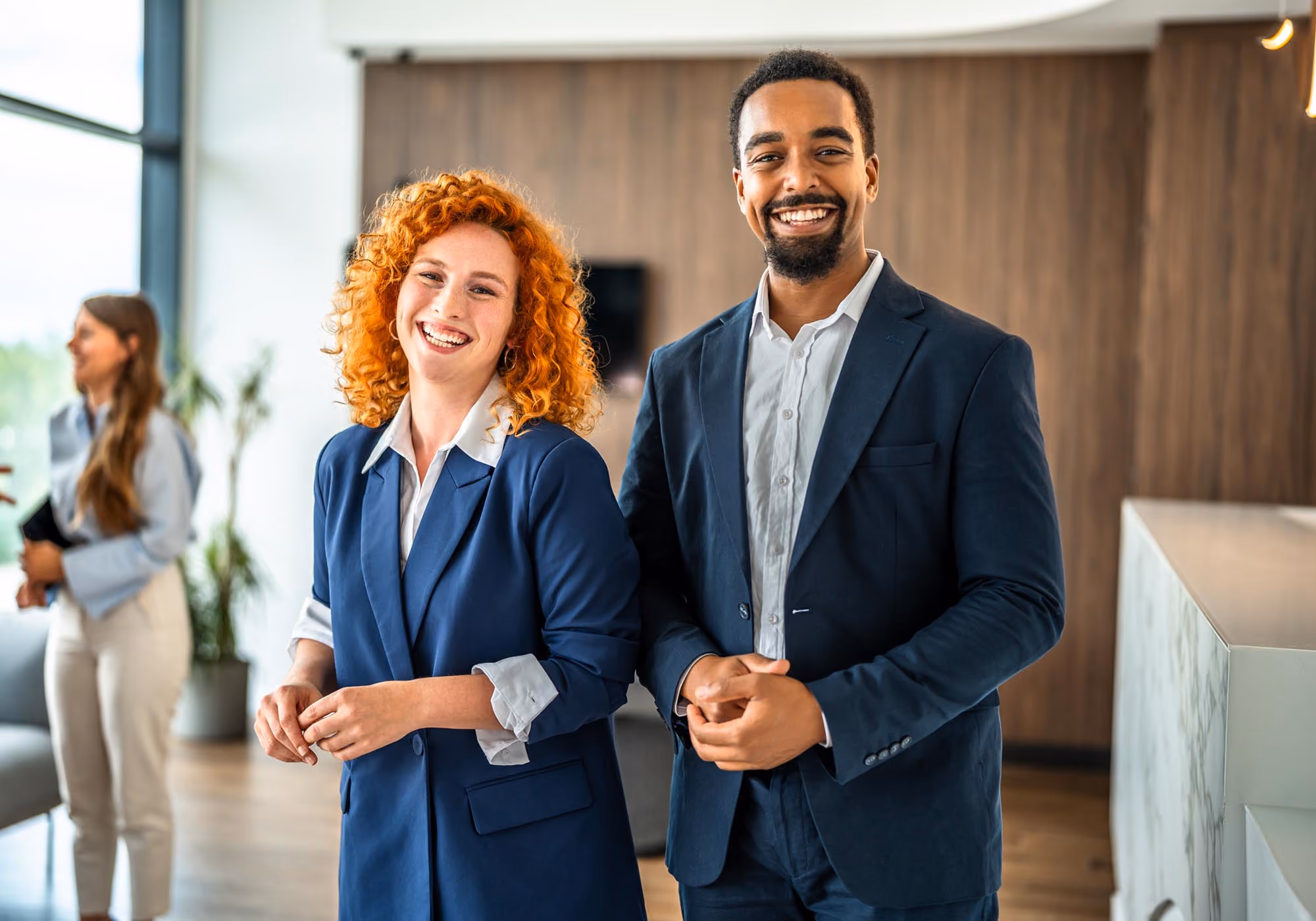Two business-casual tax and accounting professionals in a modern office