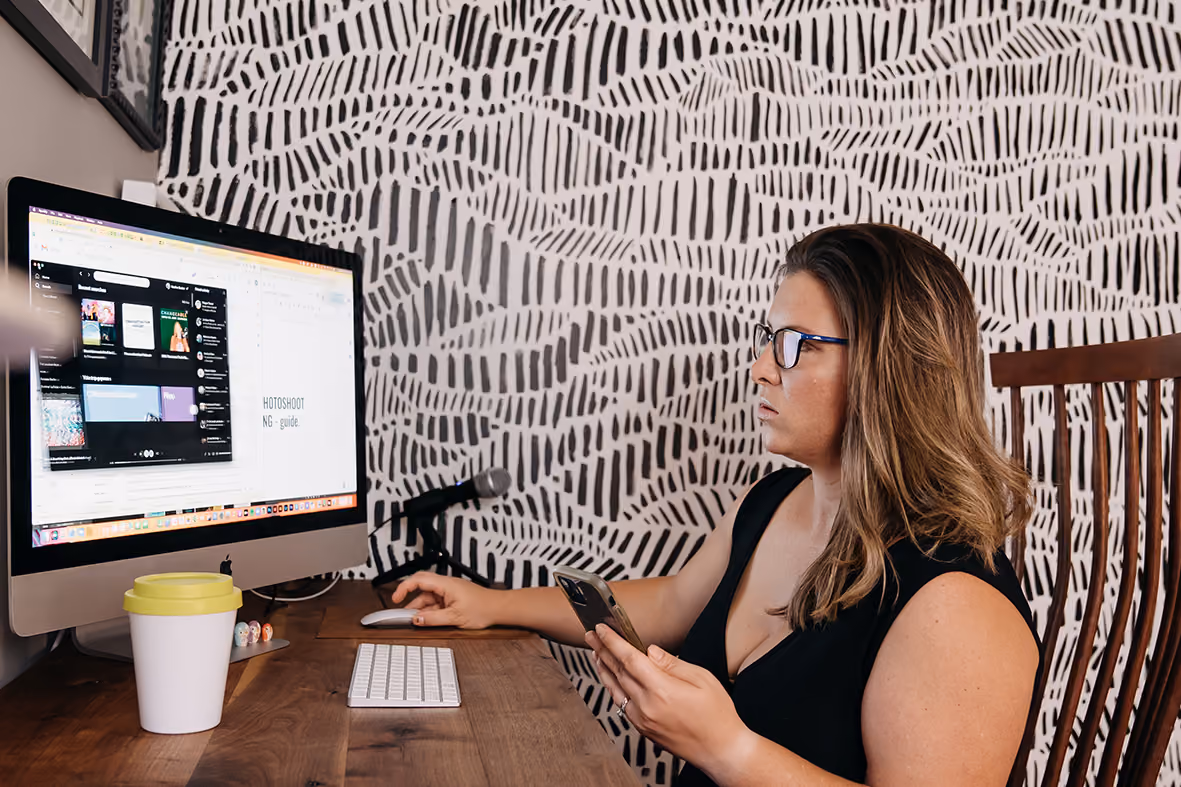 Heather Bunker sitting at desk working on strategy for creative businesses.