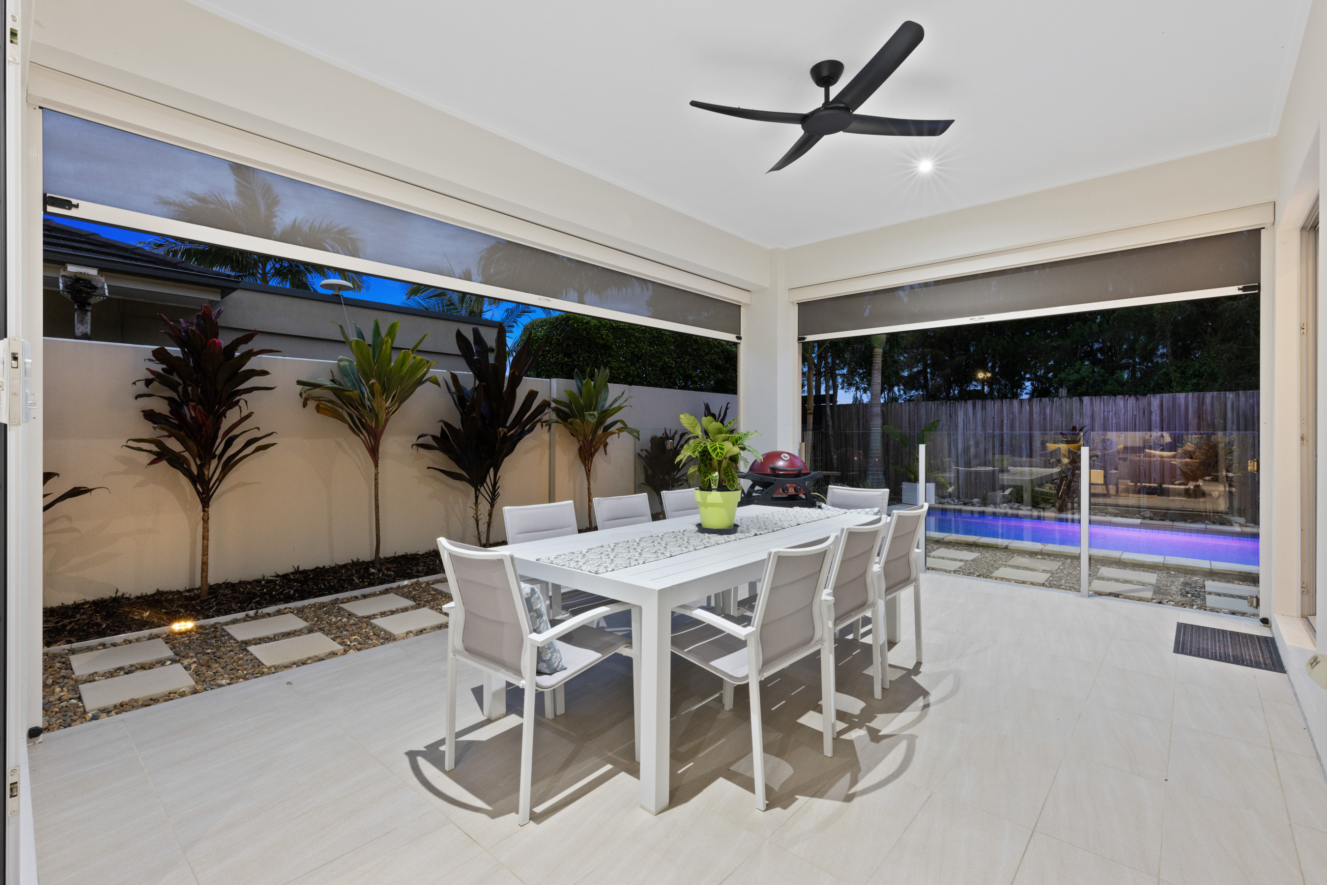 Covered outdoor entertaining area overlooking a swimming pool