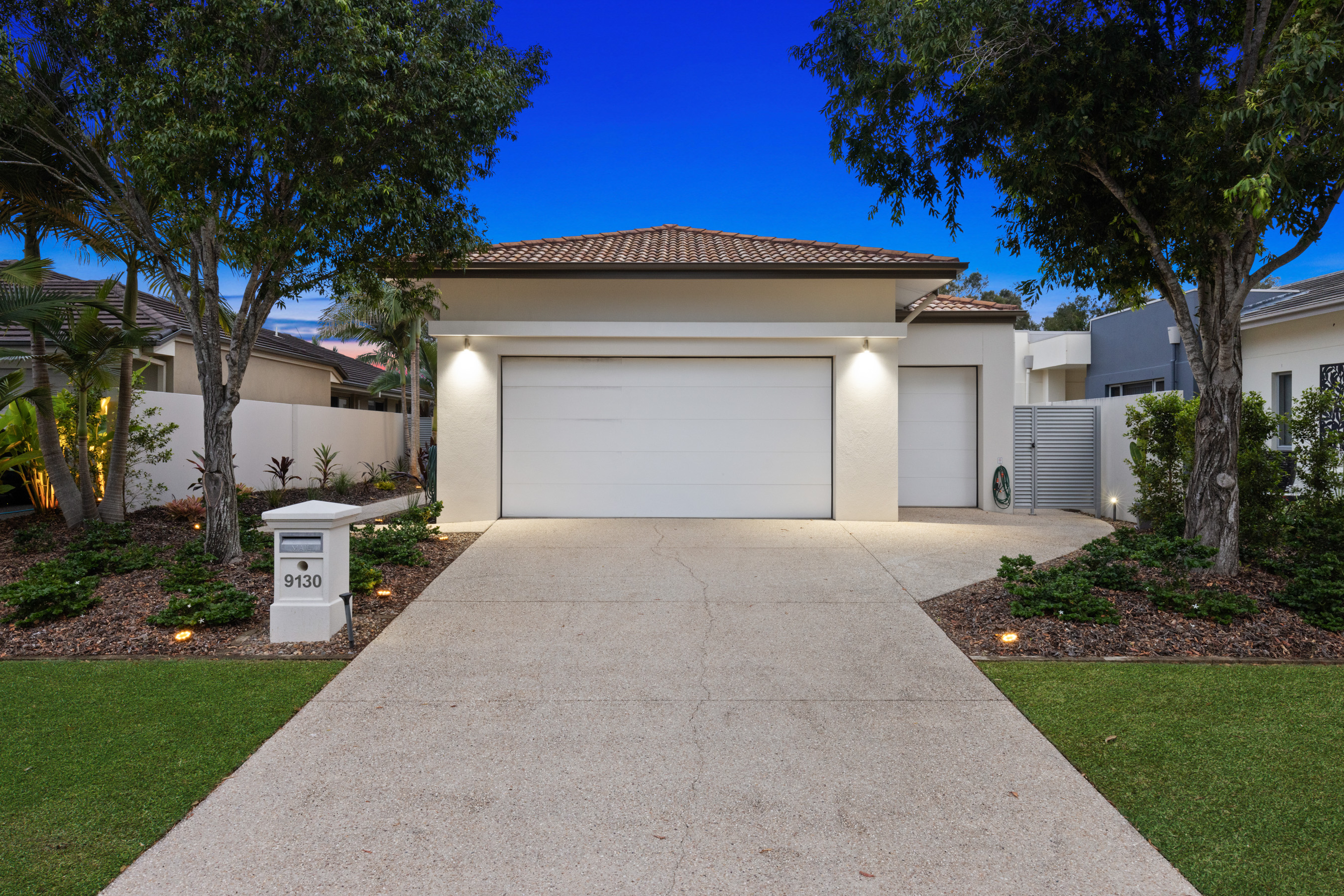 Single-storey home exterior photographed at twilight
