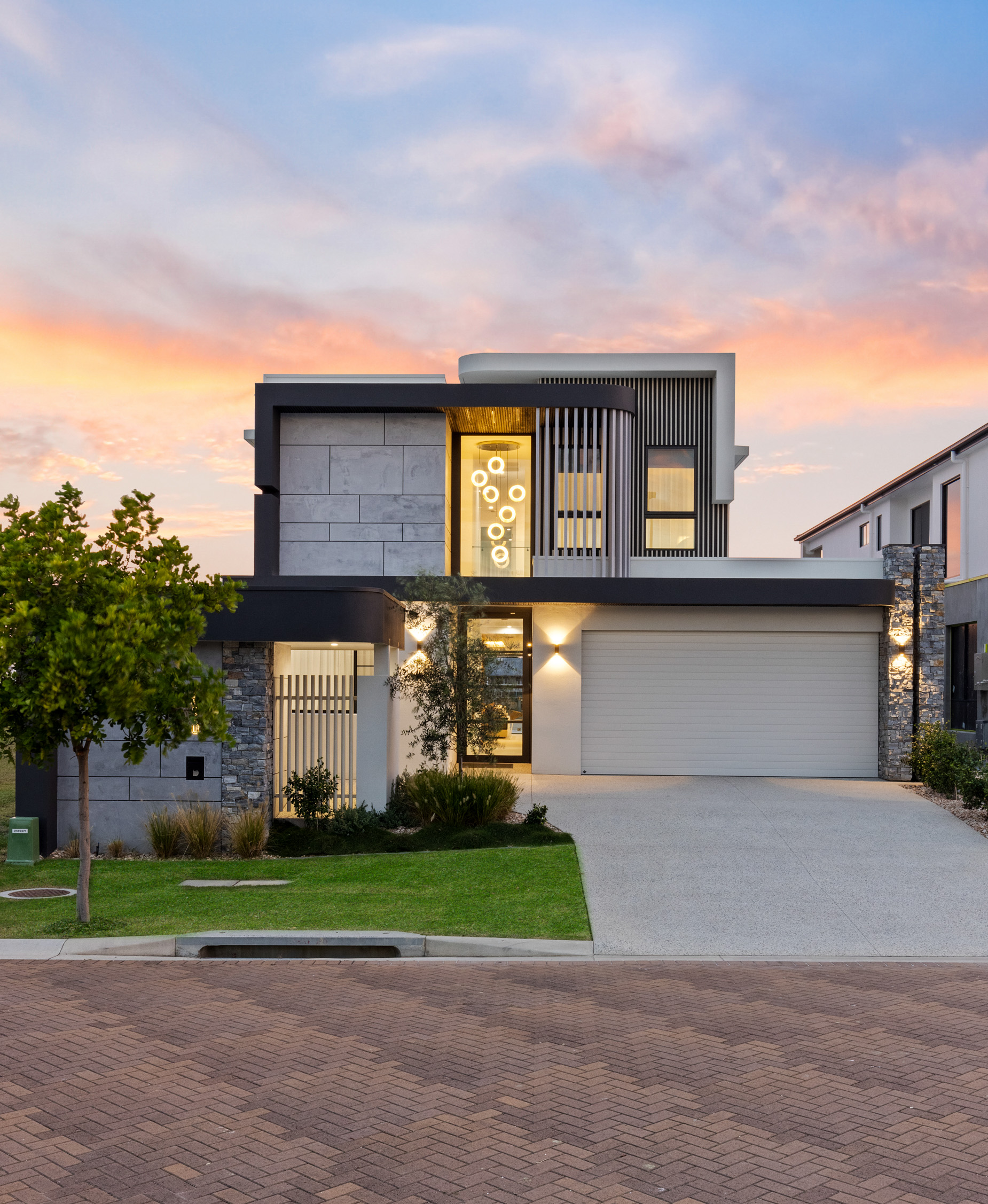 Modern two-storey home photographed at sunset for real estate marketing