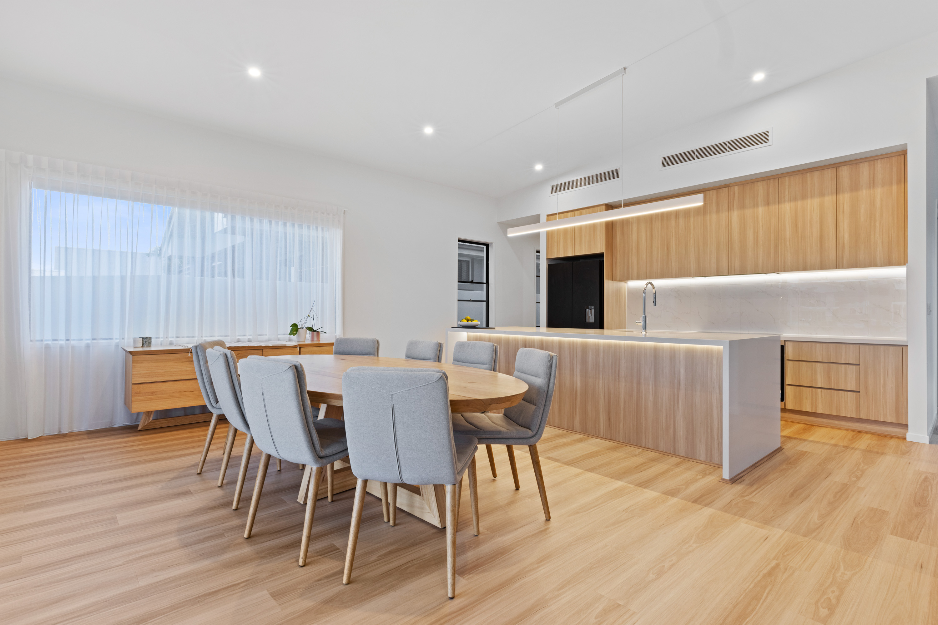 Open-plan kitchen and dining area with timber flooring