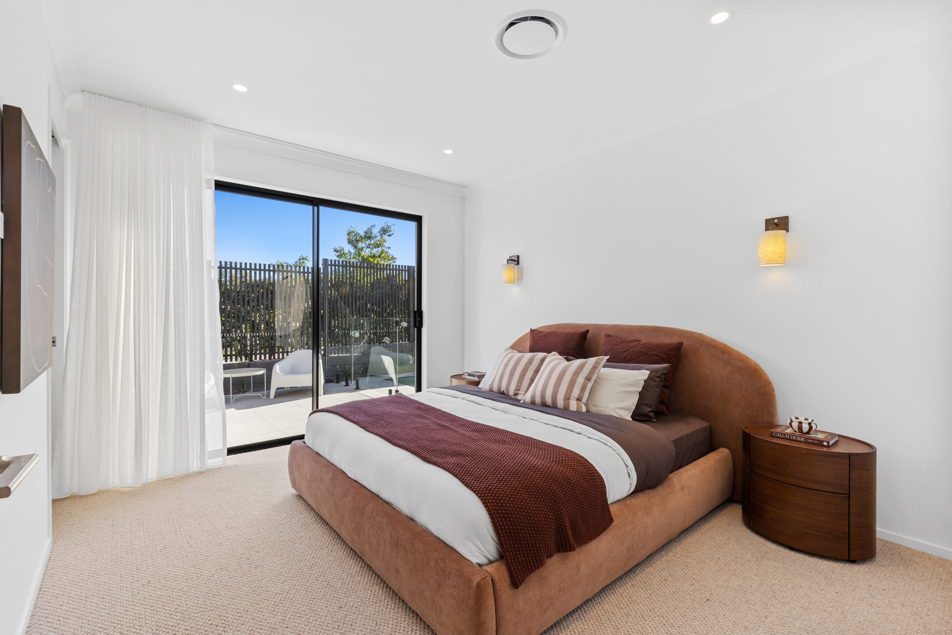 Modern bedroom with feature bedhead and outdoor access