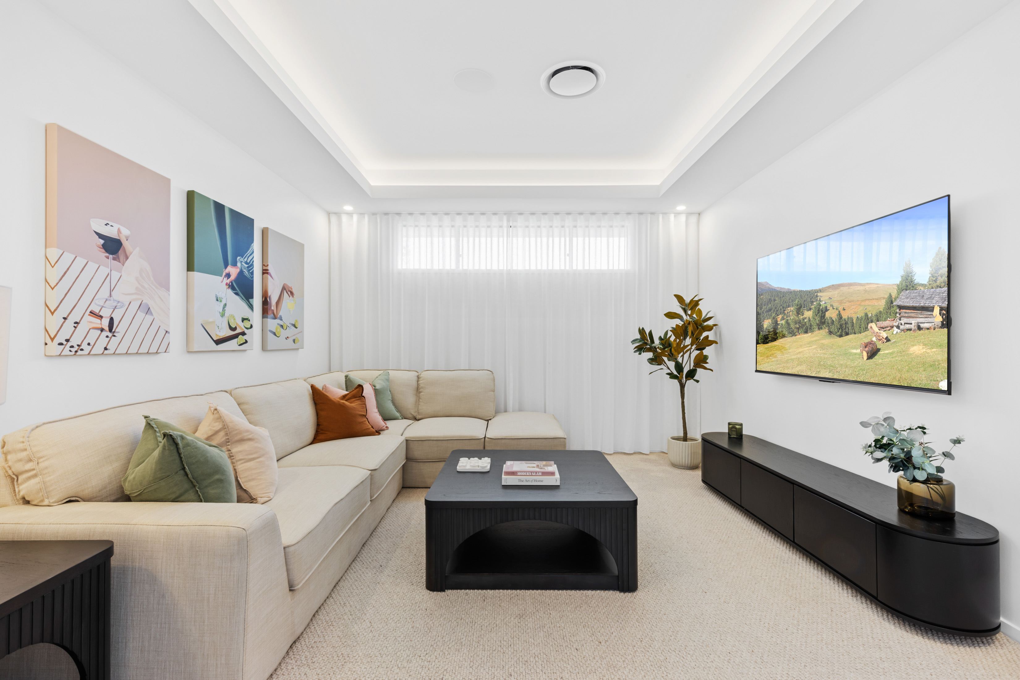 Bright modern living room with large windows and built-in television