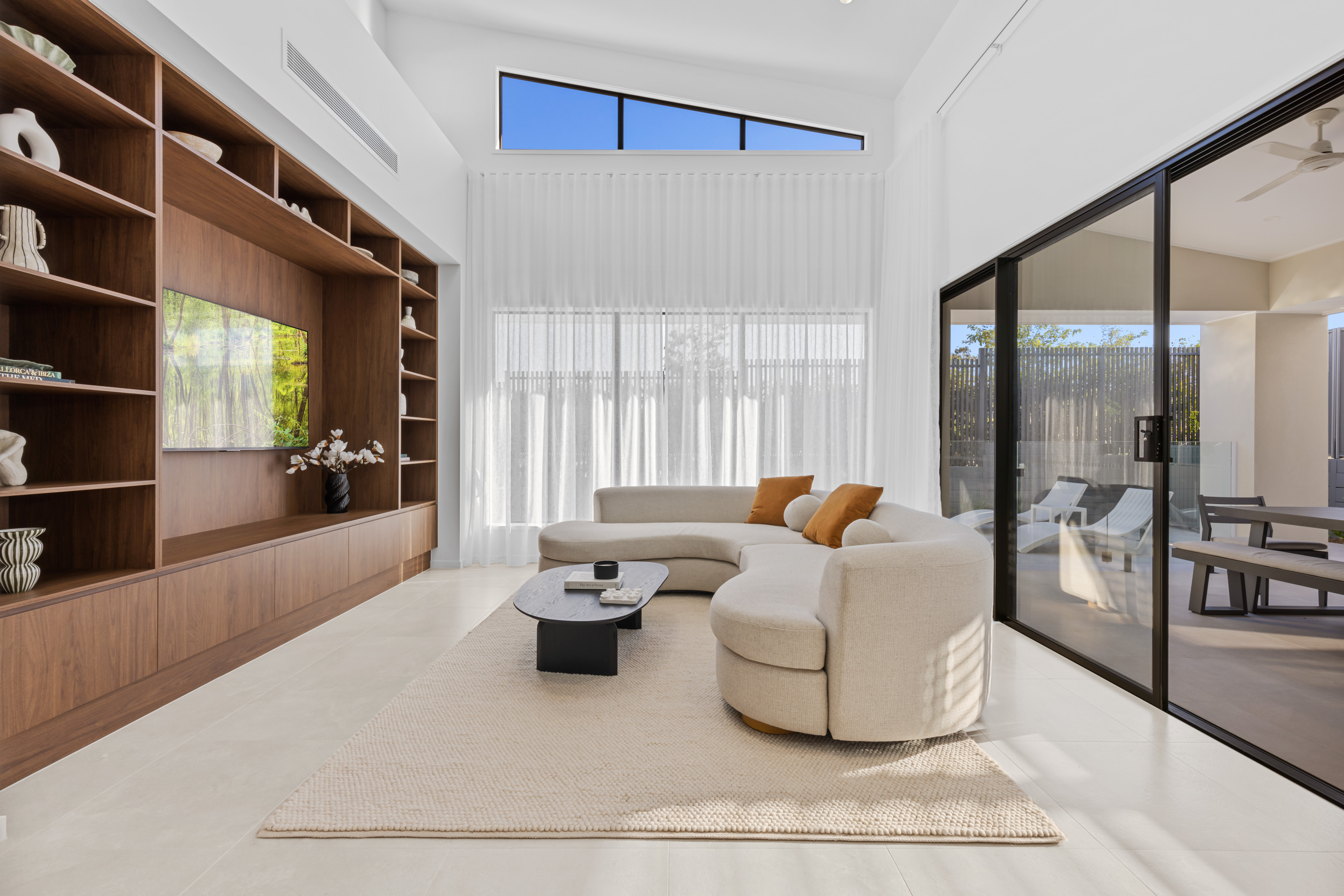 Modern custom home living area with built-in timber cabinetry