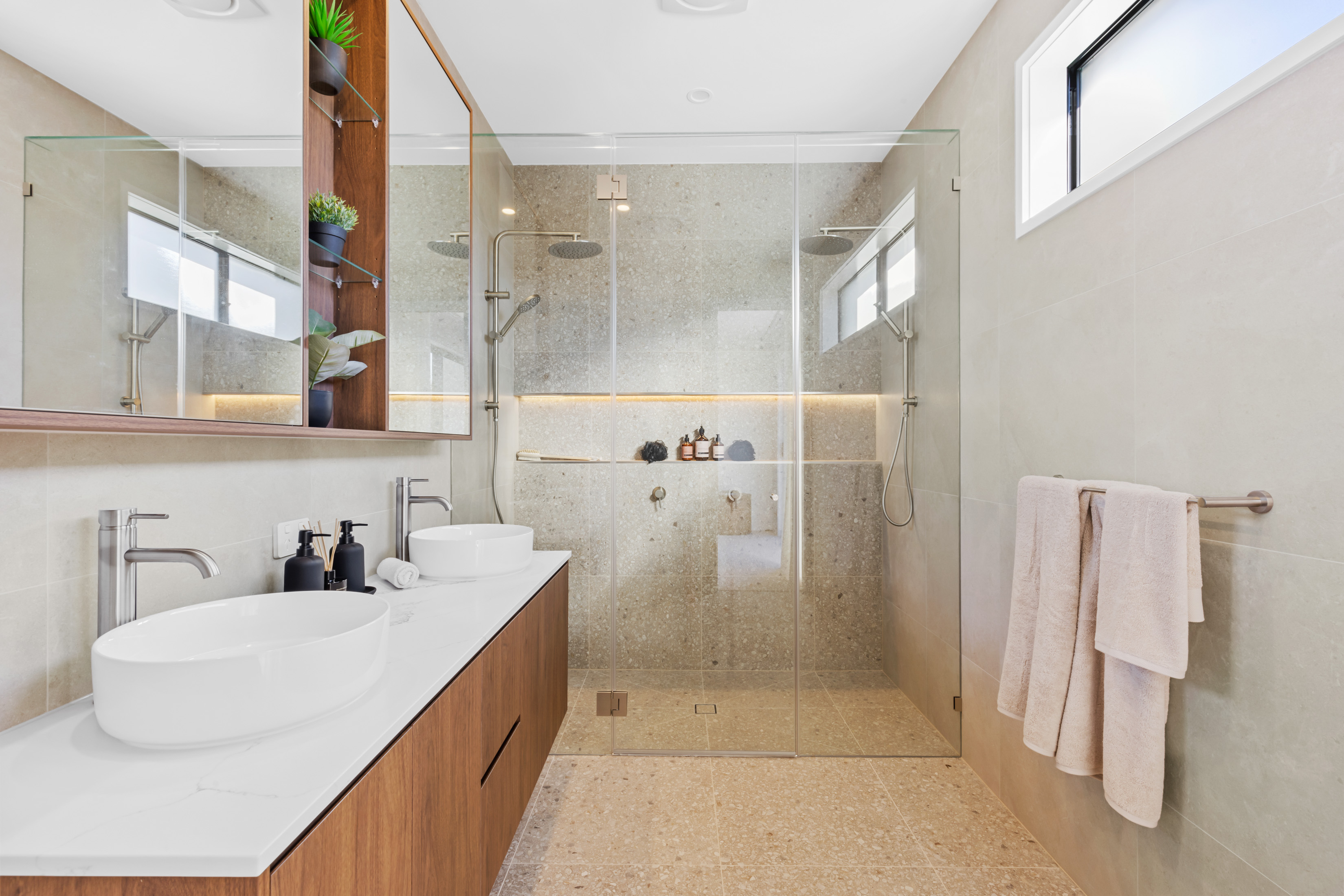Custom home bathroom with double vanity and walk-in shower
