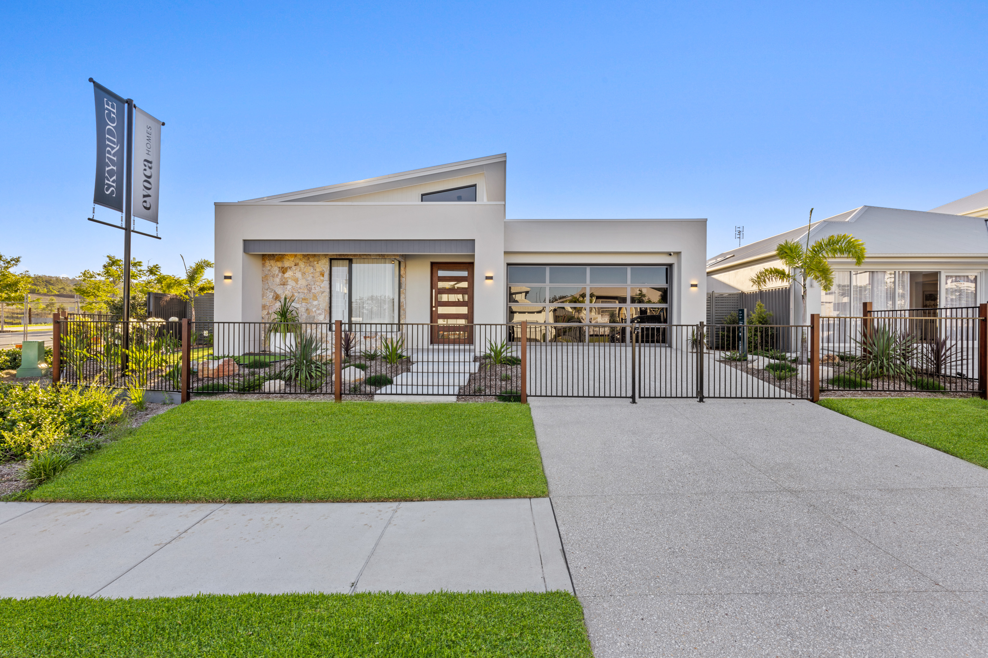 Newly completed custom home with landscaped front exterior