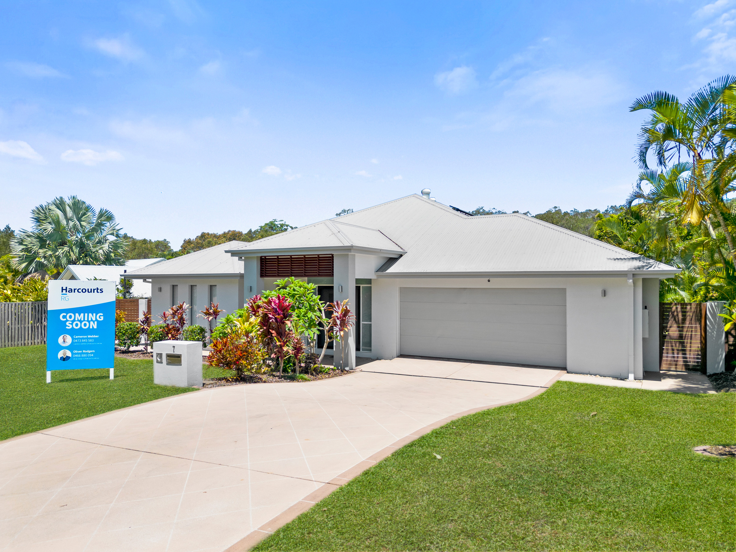 Newly completed custom home with landscaped front exterior