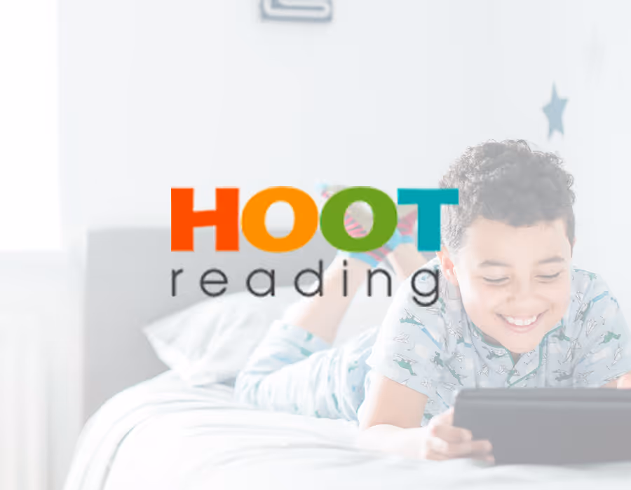 Image of a boy looking at a tablet with the Hoot Reading logo overlayed on top. 