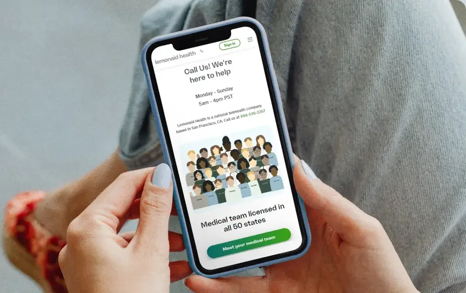Hands holding a phone showing the Lemonaid Health website
