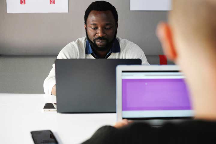 man typing on laptop