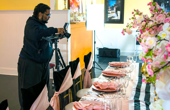 Videographer filming decorative table setting