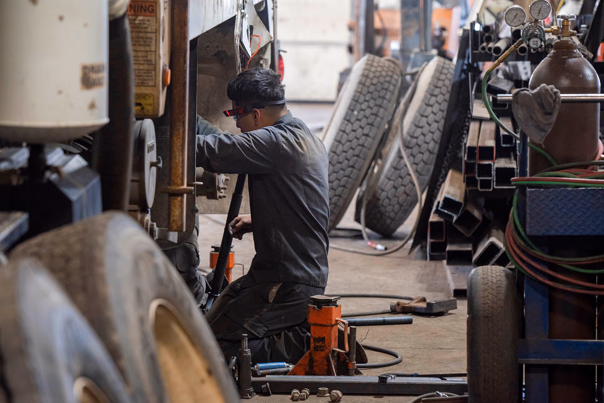 Mechanic repairing truck tire at Schroeder Truck Repair