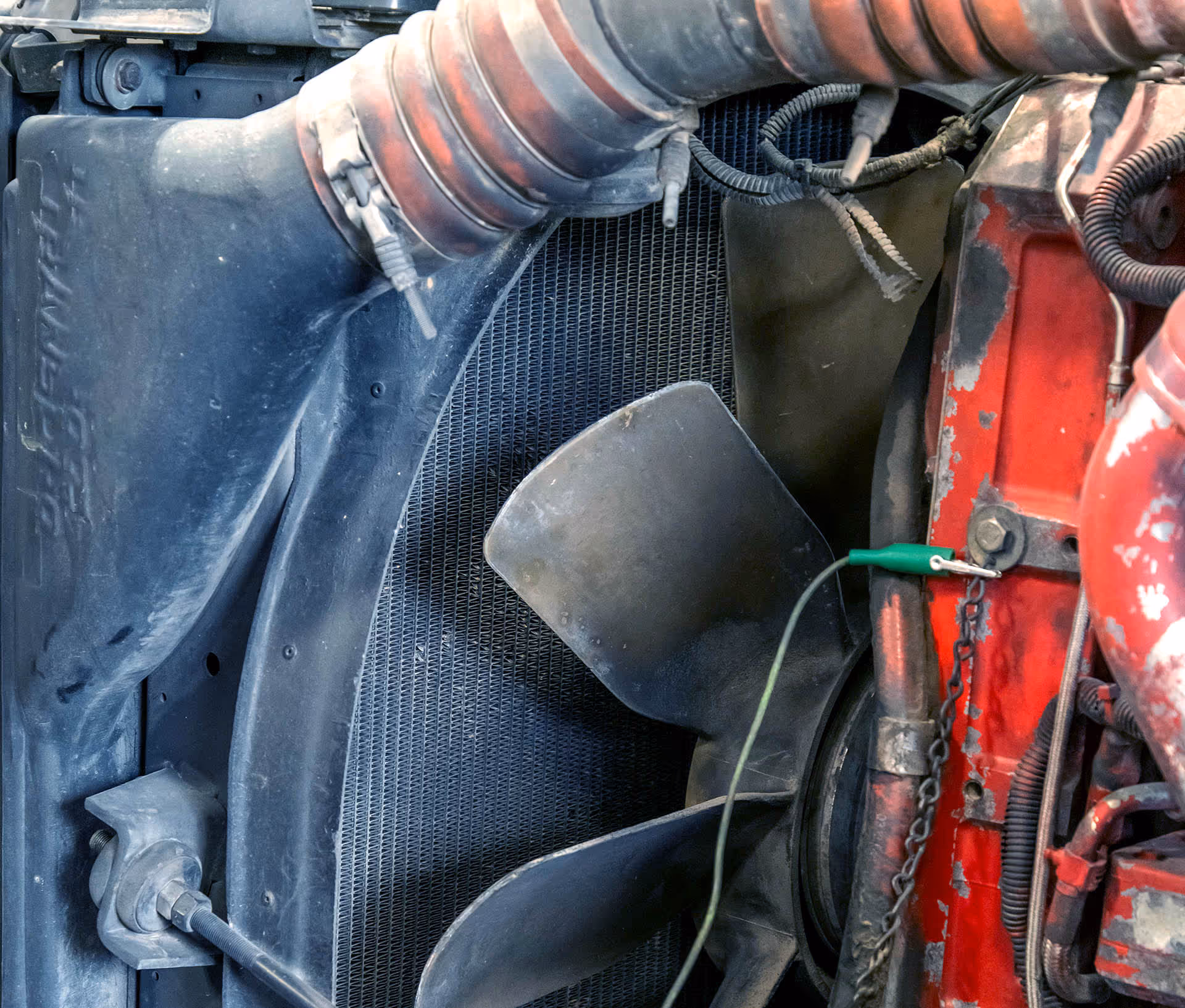 Mechanic repairing coolant system of truck at Schroeder Truck Repair