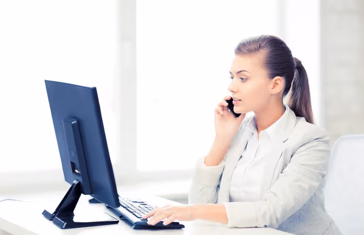 Woman answering phone for dental practice