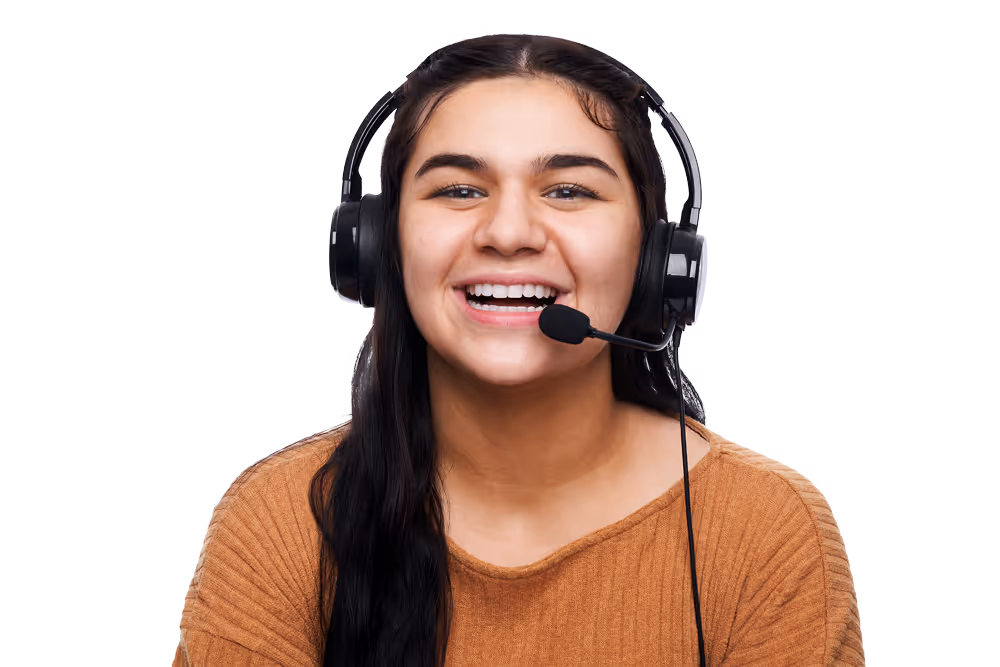Smiling young woman with long dark hair wearing a headset with microphone against a white background.