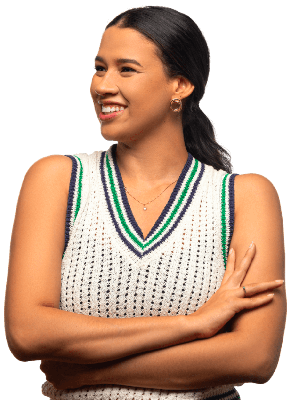 Smiling woman with dark hair pulled back wearing a sleeveless white knit top with green and navy stripes, and gold hoop earrings.