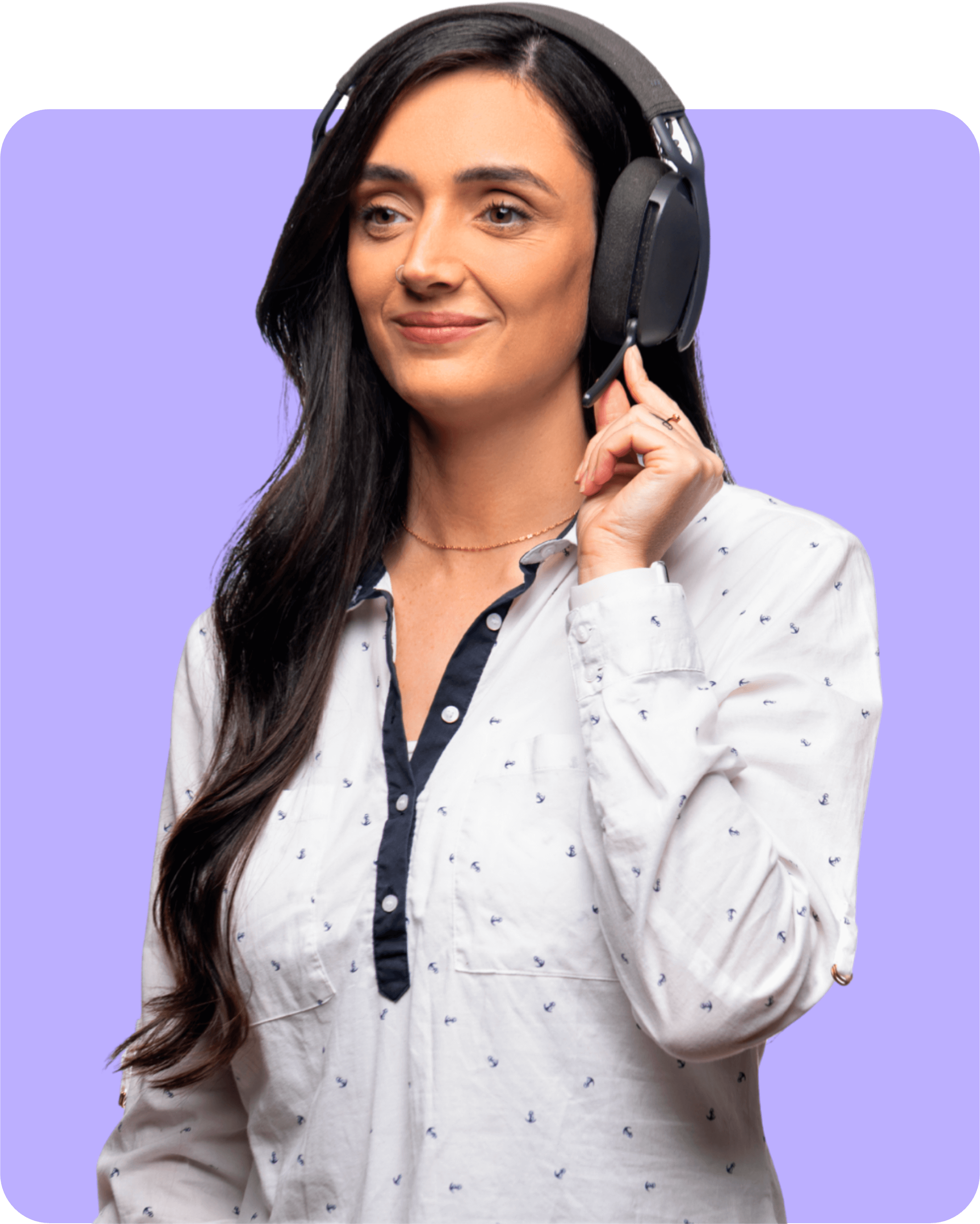 Woman with long dark hair wearing a white shirt with small anchors and a headset, touching the earpiece.