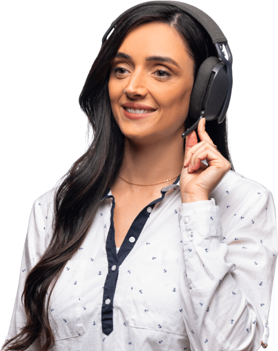 Smiling woman with long dark hair wearing a white shirt and black headset, adjusting the headset microphone.