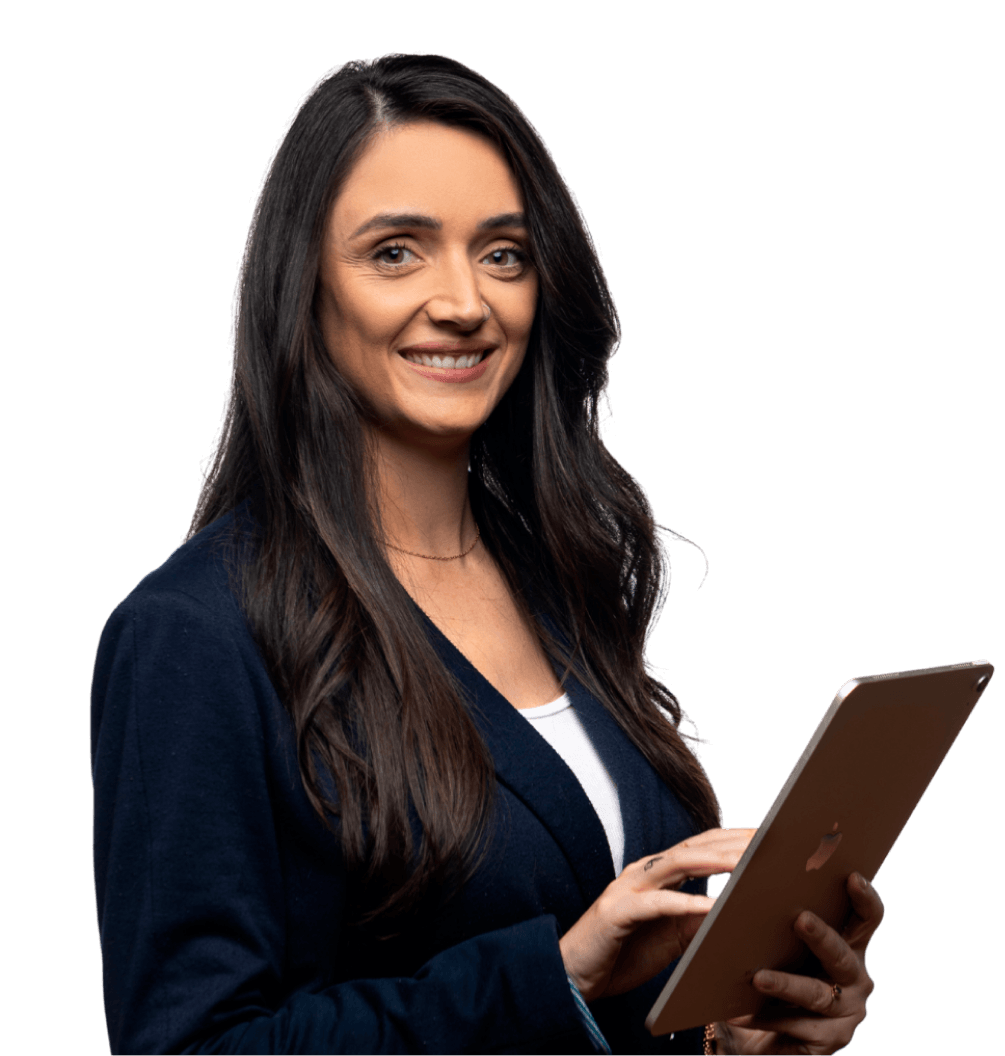 Smiling woman with long dark hair wearing a navy blazer, holding and using a tablet.