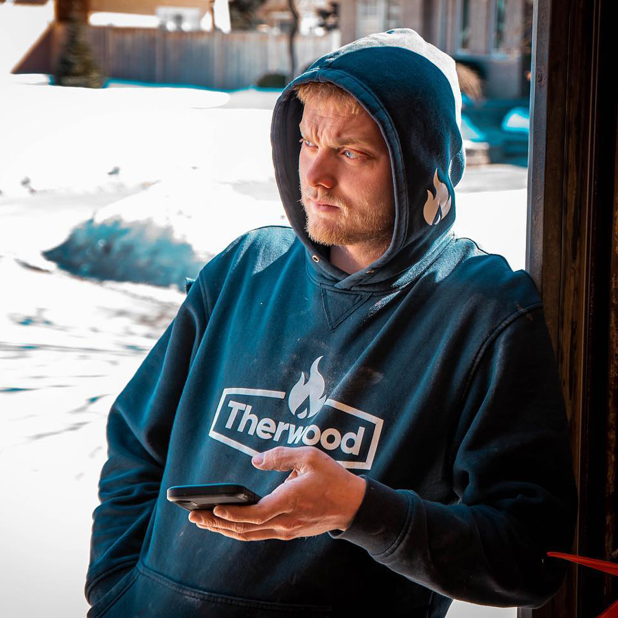 Therwood employee with branded sweatshirt.