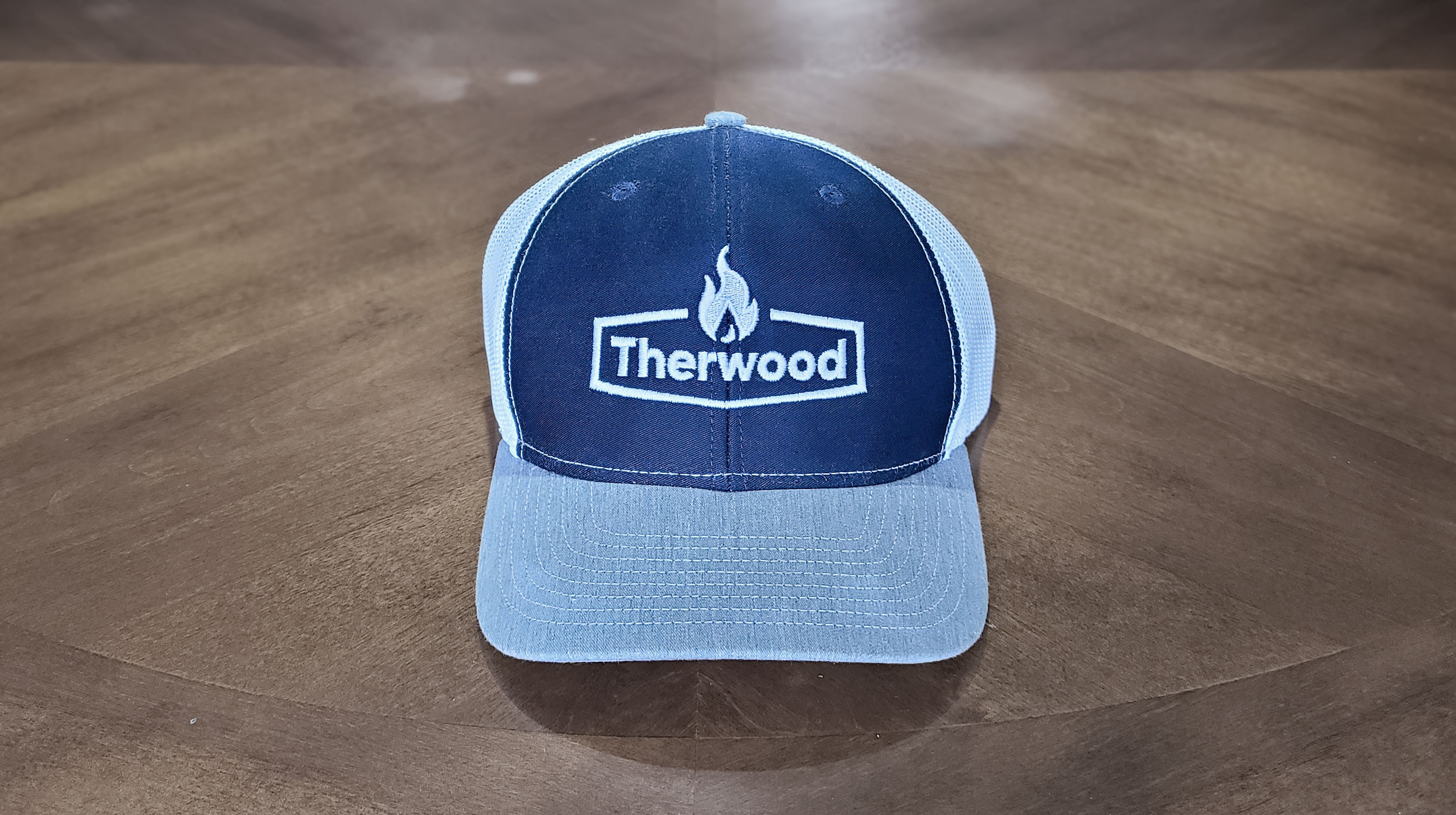 Therwood branded hat resting on table.