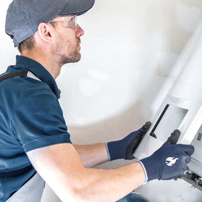 Therwood employee fixing a furnace.