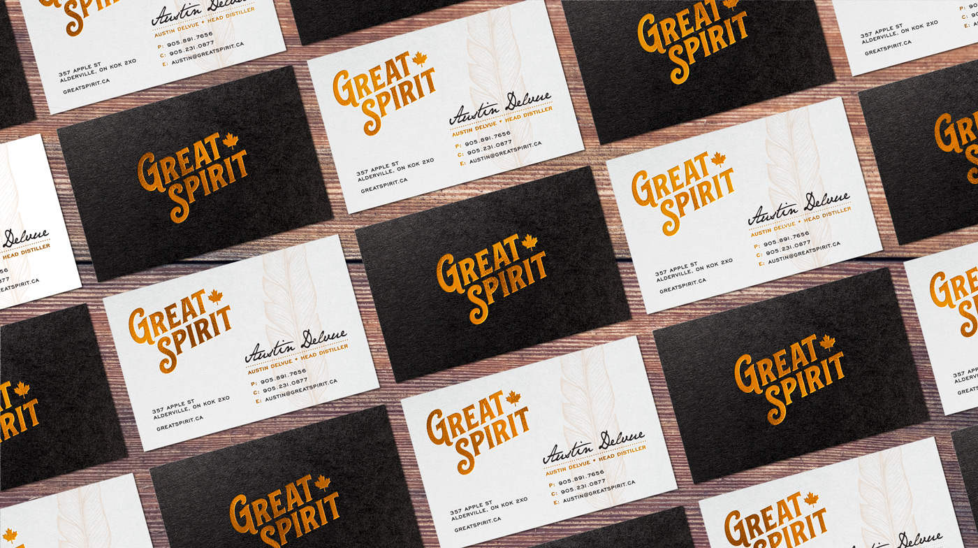 Many Great Spirit business cards cascading across a table surface.