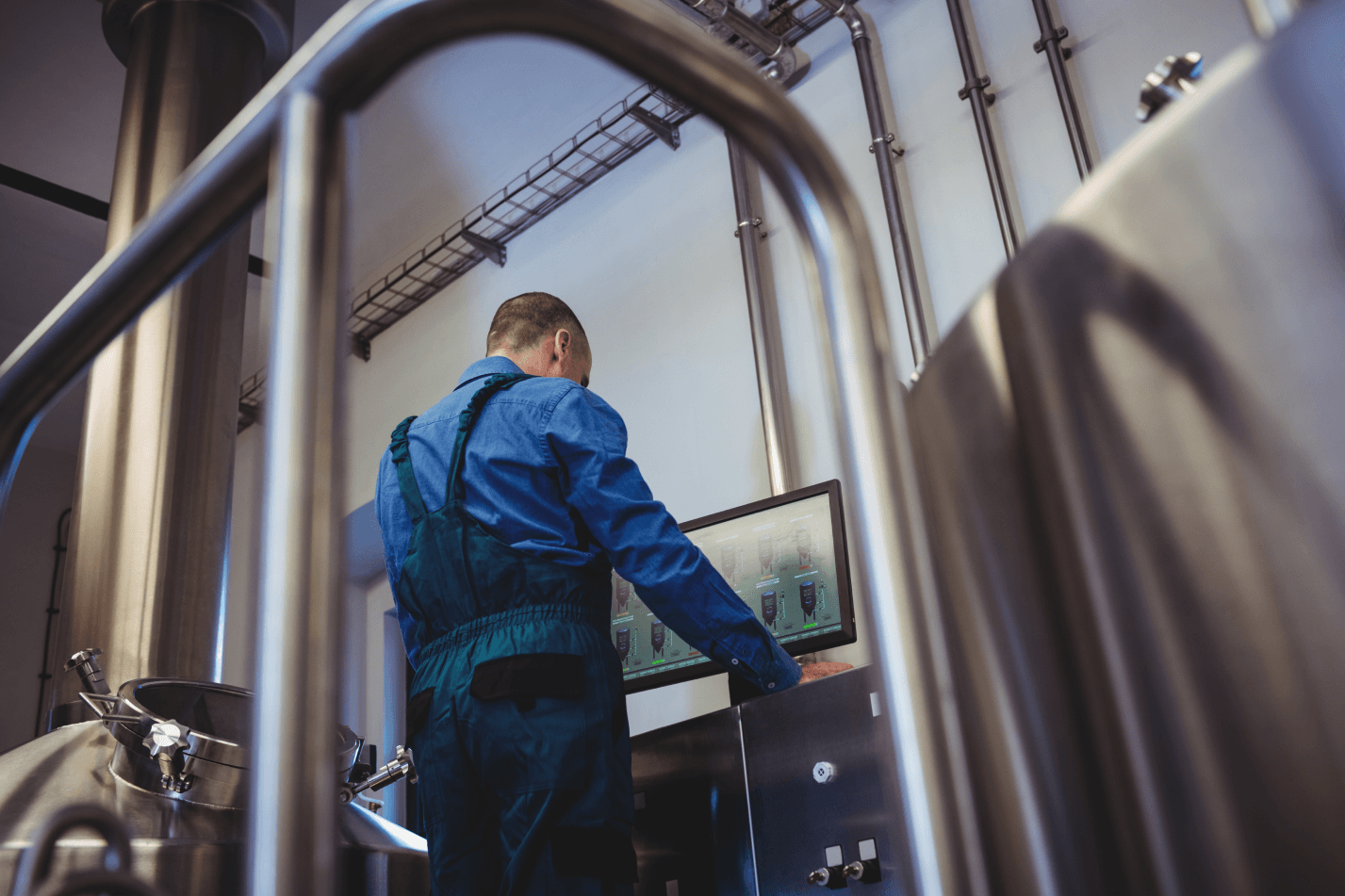 image of worker looking at tank levels