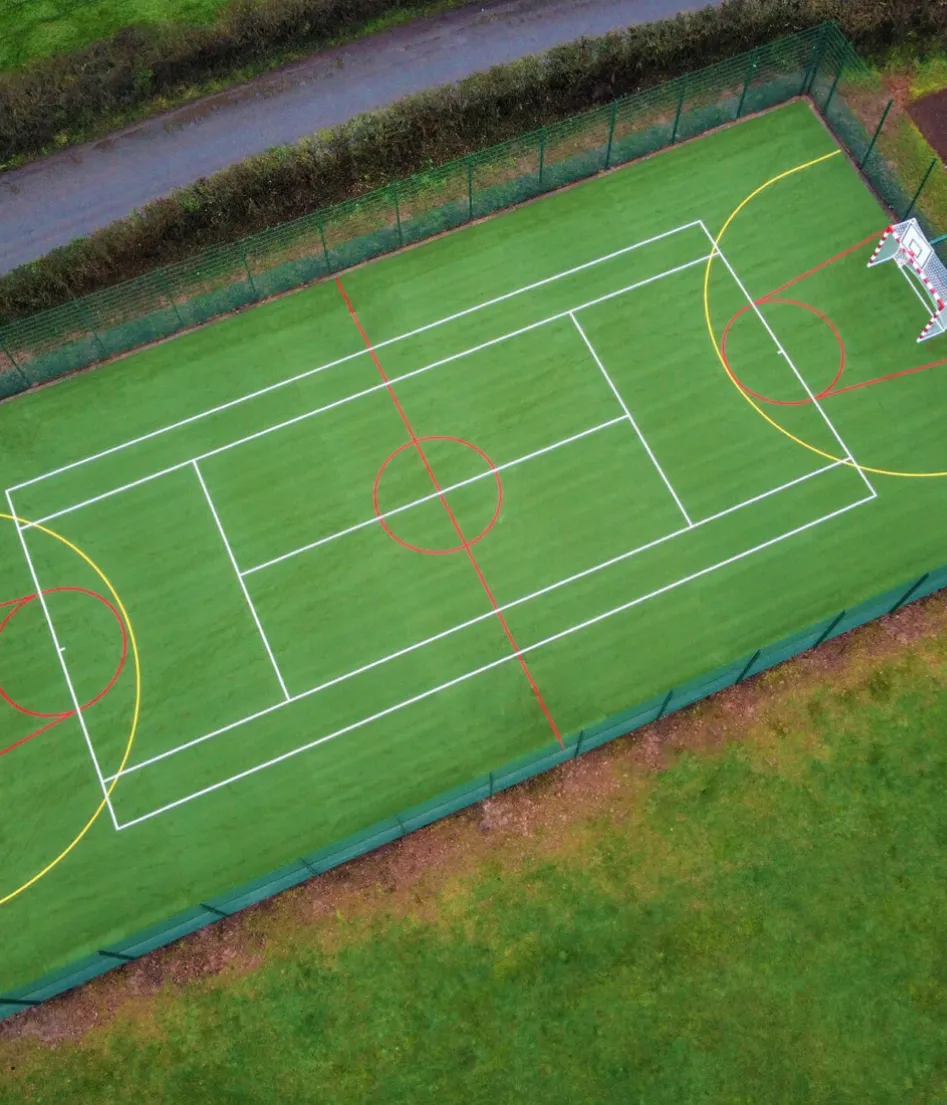 A tennis court with a green surface and white lines.
