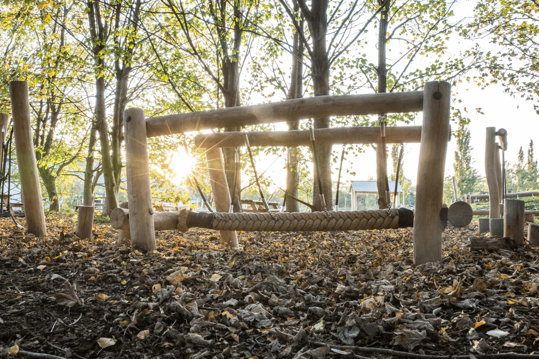 A wooden fence with a rope hanging from it.
