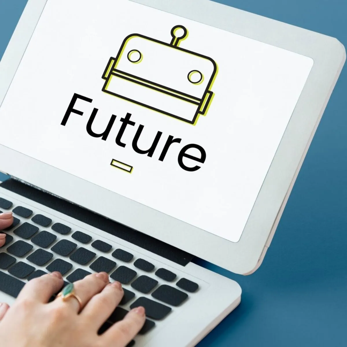 A person using a laptop displaying a robot icon with the word "Future" on the screen.