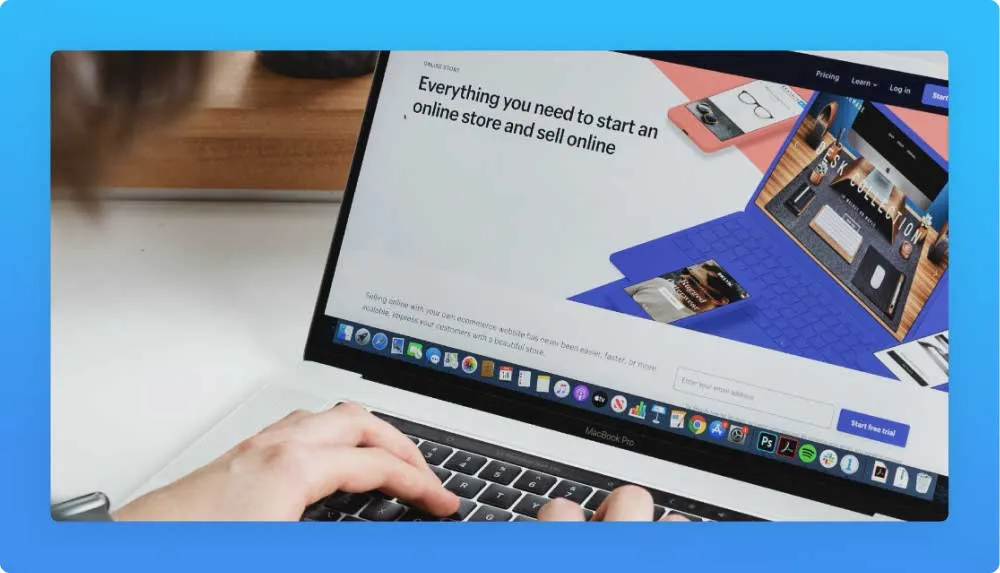Person using a laptop displaying an e-commerce platform's homepage.