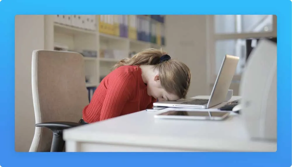Tired millennial woman with head over the laptop showing signs of needing a career change