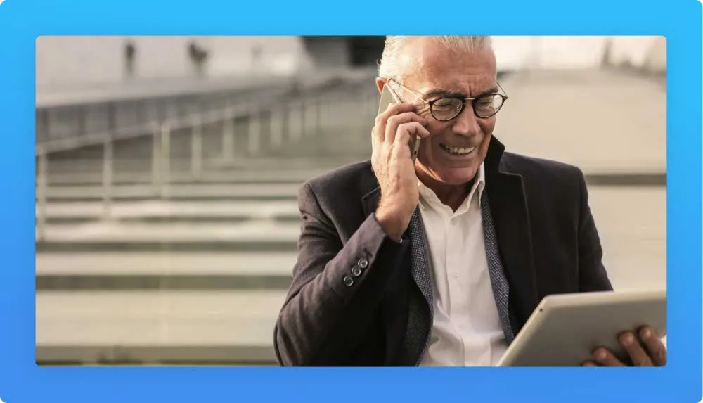 50 years old entrepreneur on a phone call and holding a tablet happily smiling about his career choices
