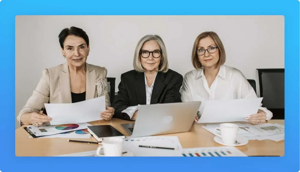 3 professional women on their 50's looking to spreadsheets and laptop reinventing a career change