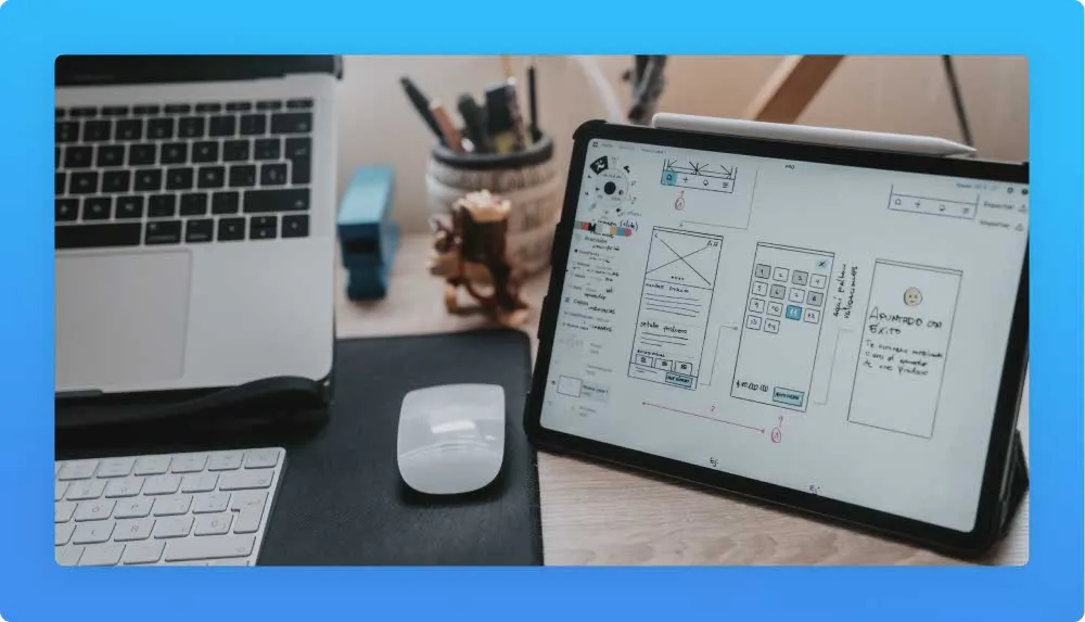 Two keyboards, mouse and tablet displaying an app building and development 