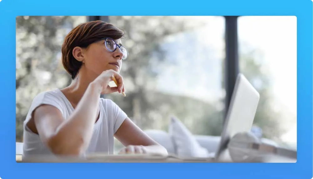 Woman on laptop daydreaming with the opportunity for a career change from accounting